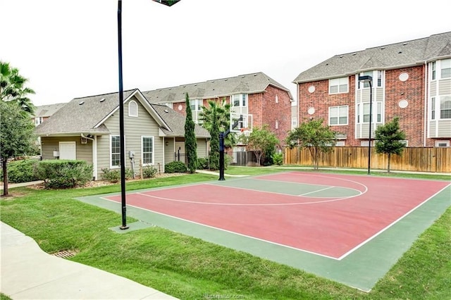 view of basketball court with a yard