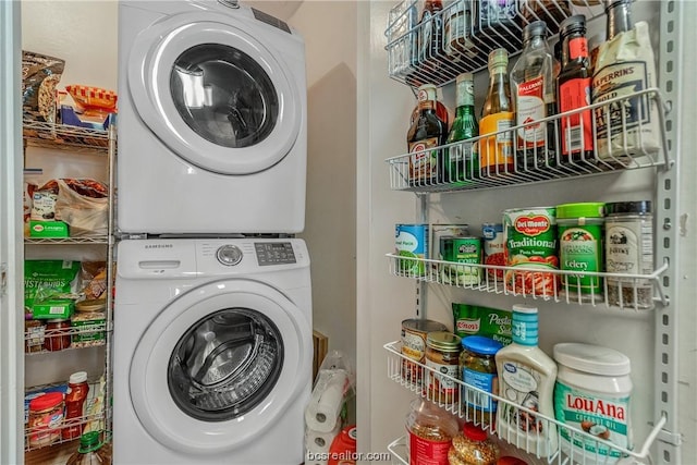 washroom featuring stacked washing maching and dryer