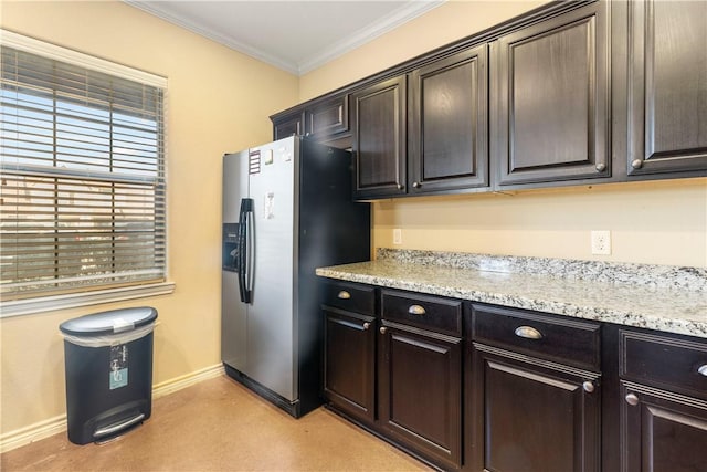 kitchen featuring ornamental molding, dark brown cabinets, light stone counters, and stainless steel fridge with ice dispenser