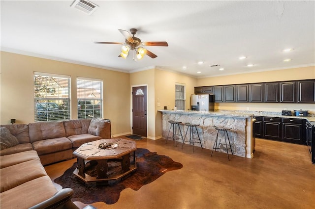 living room featuring crown molding and ceiling fan