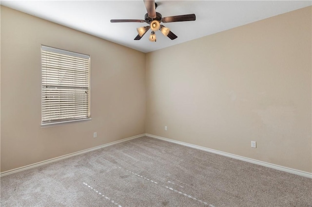 carpeted spare room with ceiling fan