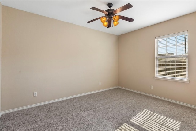 carpeted empty room featuring ceiling fan