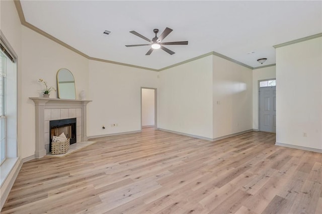 unfurnished living room with crown molding, a fireplace, ceiling fan, and light hardwood / wood-style floors