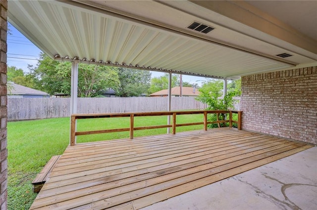 wooden terrace featuring a lawn