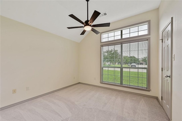 carpeted spare room featuring ceiling fan and vaulted ceiling