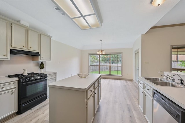 kitchen featuring a center island, sink, black range with gas stovetop, stainless steel dishwasher, and a notable chandelier