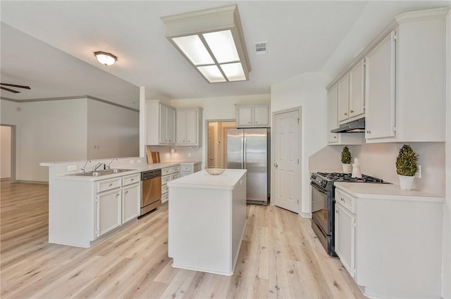 kitchen with a center island, light wood-type flooring, kitchen peninsula, and stainless steel appliances