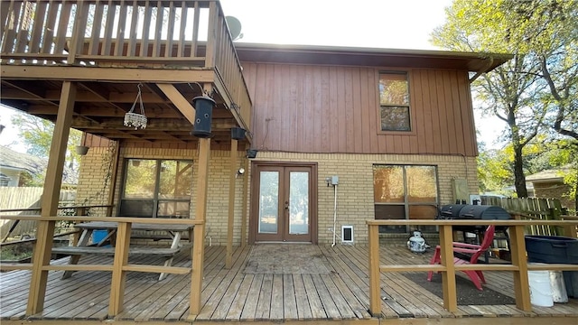 rear view of house featuring french doors and a wooden deck