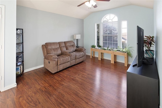 living room featuring ceiling fan, dark hardwood / wood-style floors, and vaulted ceiling