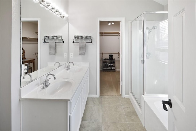 bathroom with tile patterned floors, vanity, and separate shower and tub