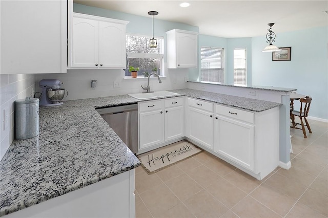 kitchen featuring white cabinetry, decorative light fixtures, and dishwasher