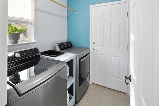 laundry area featuring light tile patterned flooring and separate washer and dryer