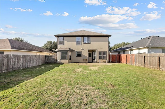 back of house with a lawn