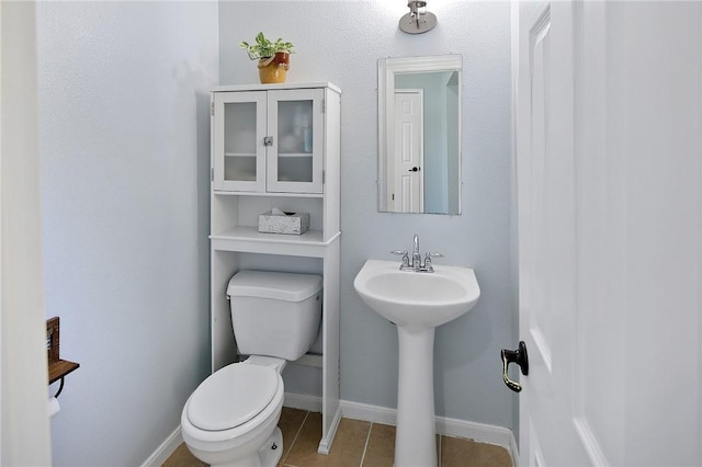 bathroom featuring tile patterned flooring and toilet