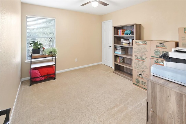 interior space with light carpet and ceiling fan