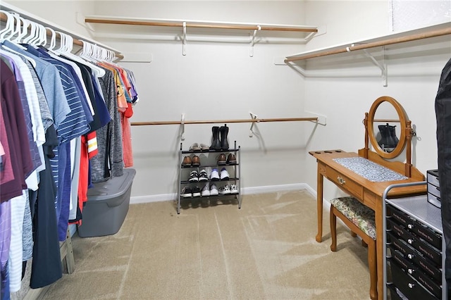 walk in closet with carpet