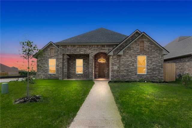 view of front of property with a yard