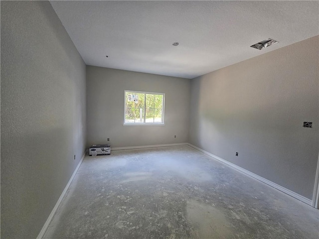1112 Justine, Bryan, TX 77803 - spare room featuring concrete flooring and baseboards