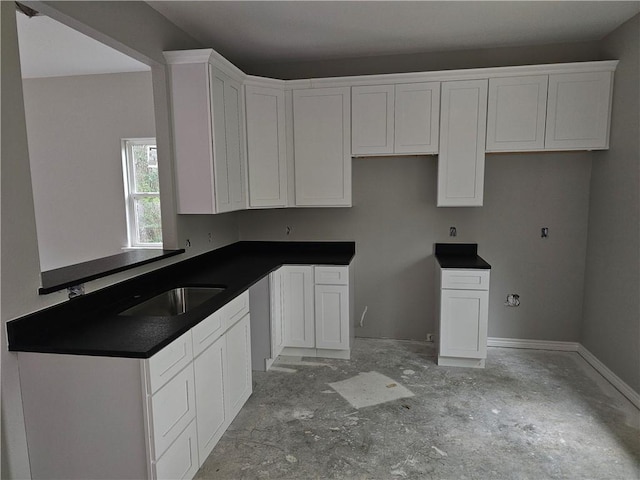1112 Justine, Bryan, TX 77803 - kitchen with white cabinetry and dark countertops