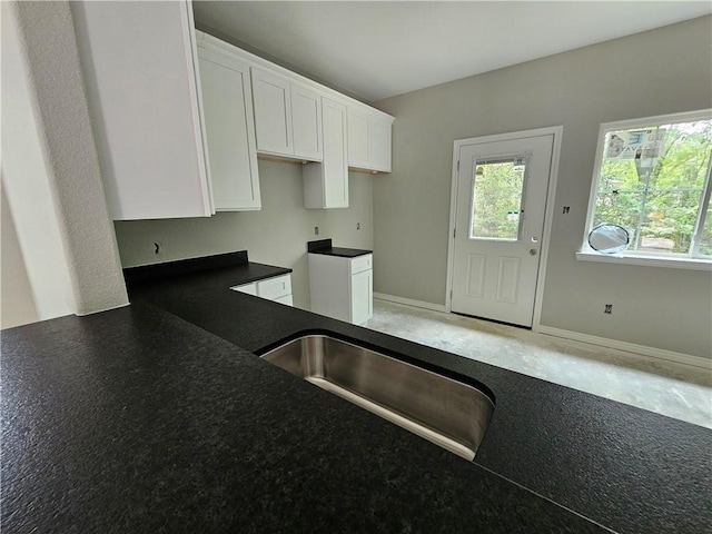1112 Justine, Bryan, TX 77803 - kitchen with white cabinetry and dark countertops