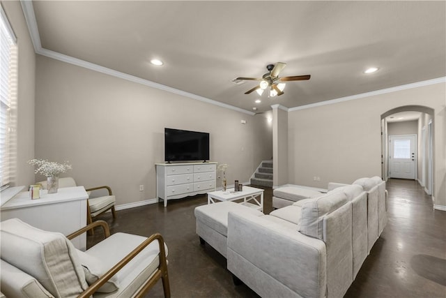 living room with ceiling fan and ornamental molding