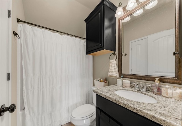 bathroom featuring toilet, vanity, and a shower with curtain