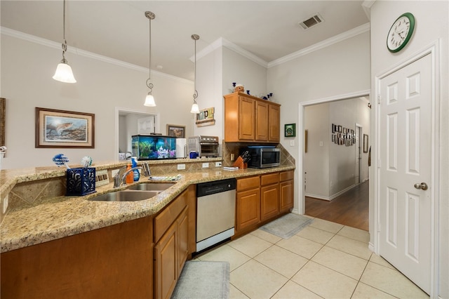 kitchen with sink, decorative light fixtures, light tile patterned floors, stainless steel appliances, and light stone countertops