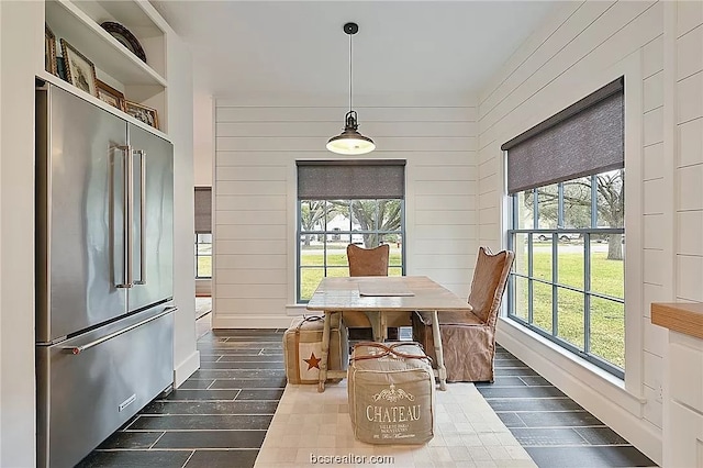 dining room featuring wooden walls