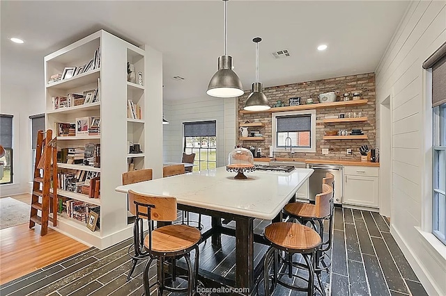 dining room featuring sink and dark hardwood / wood-style floors