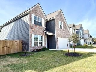 view of front of property featuring a front lawn and a garage