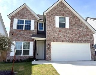 2126 Mountain Wind Loop, Bryan, TX 77807 - traditional-style house featuring driveway, a front yard, brick siding, and a garage