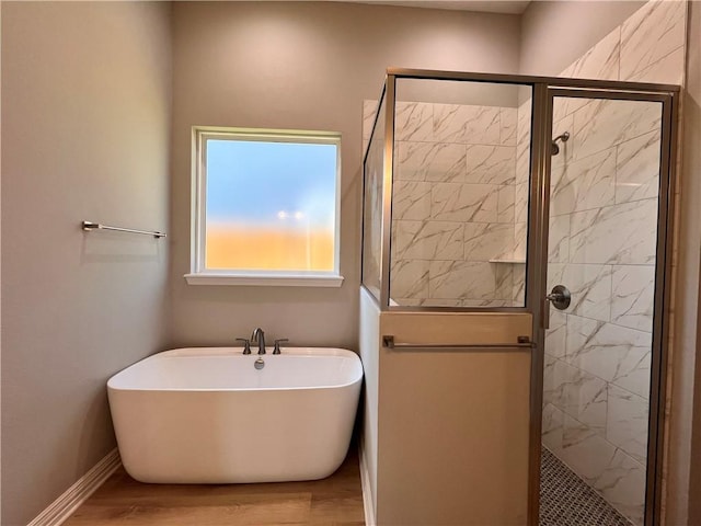 bathroom with plus walk in shower and hardwood / wood-style flooring