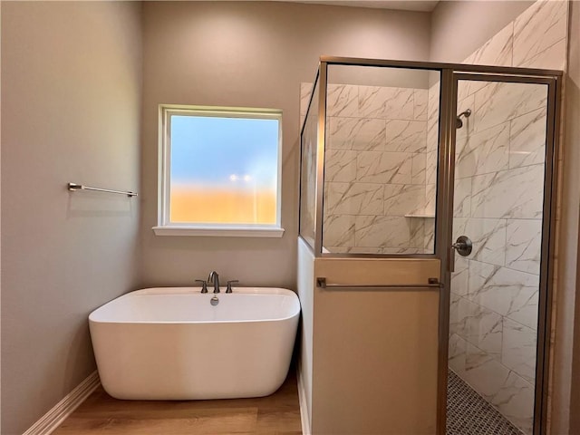 2126 Mountain Wind Loop, Bryan, TX 77807 - bathroom featuring a freestanding bath, wood finished floors, and a stall shower