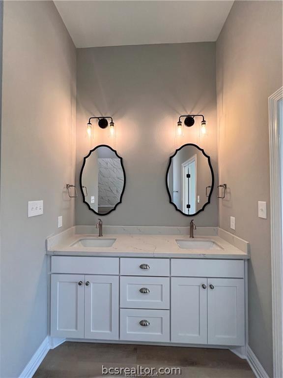 2126 Mountain Wind Loop, Bryan, TX 77807 - full bathroom with double vanity and baseboards
