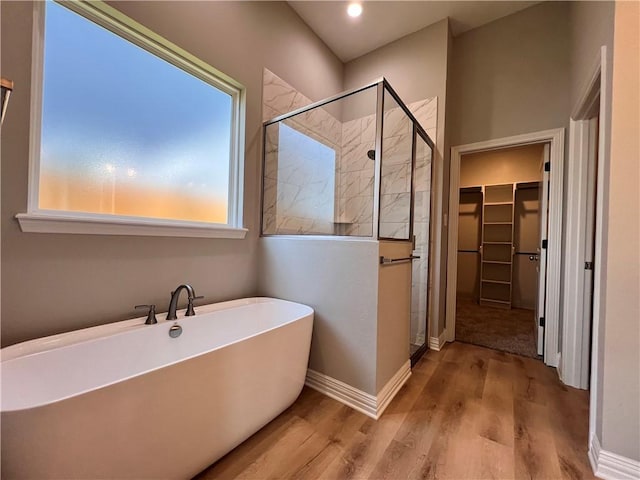 2126 Mountain Wind Loop, Bryan, TX 77807 - bathroom with a stall shower, a walk in closet, a soaking tub, wood finished floors, and recessed lighting