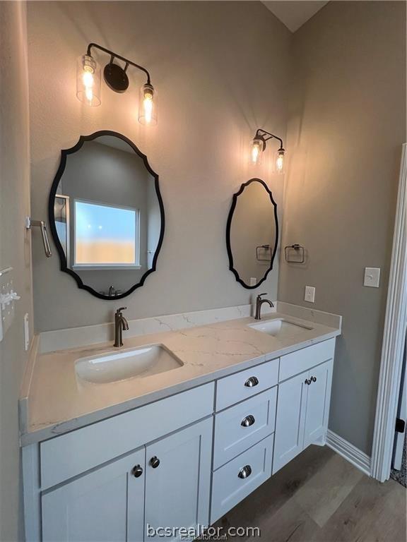 2126 Mountain Wind Loop, Bryan, TX 77807 - full bath with double vanity and wood finished floors