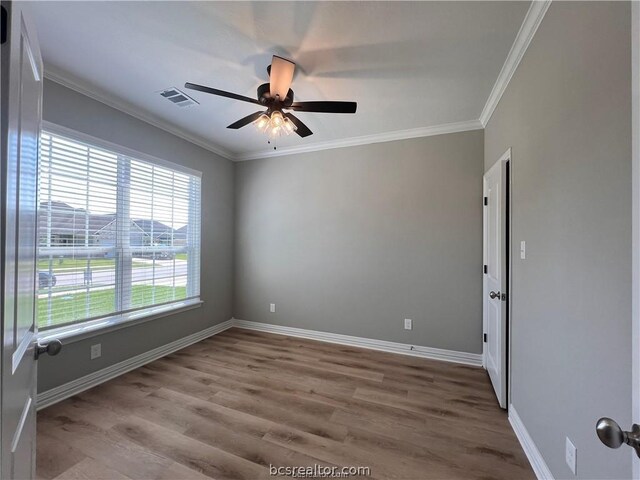 unfurnished room with ceiling fan, light wood-type flooring, and crown molding