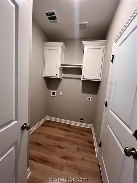 clothes washing area with washer hookup, dark hardwood / wood-style flooring, and electric dryer hookup