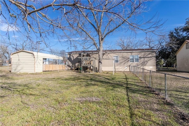 back of house with fence and a lawn