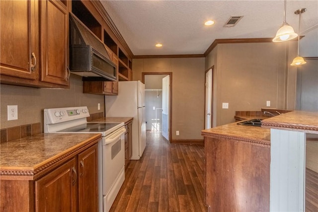 kitchen featuring white appliances, brown cabinets, a sink, and exhaust hood