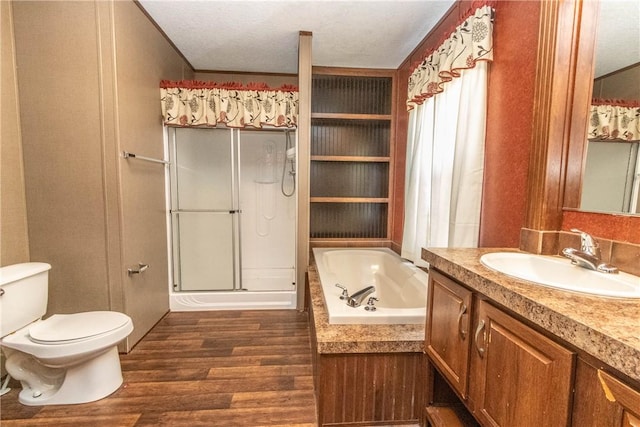 bathroom featuring toilet, wood finished floors, a garden tub, vanity, and a shower stall