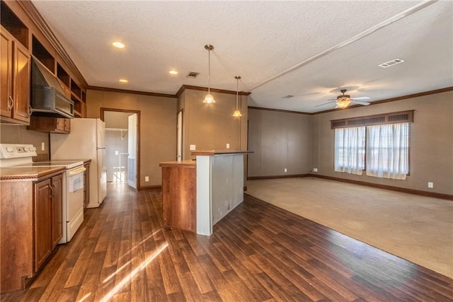 kitchen featuring ornamental molding, wall chimney exhaust hood, white appliances, and visible vents