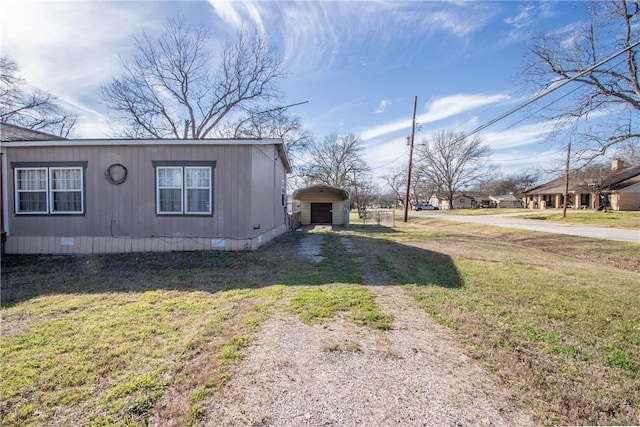 view of property exterior featuring crawl space, a lawn, and dirt driveway