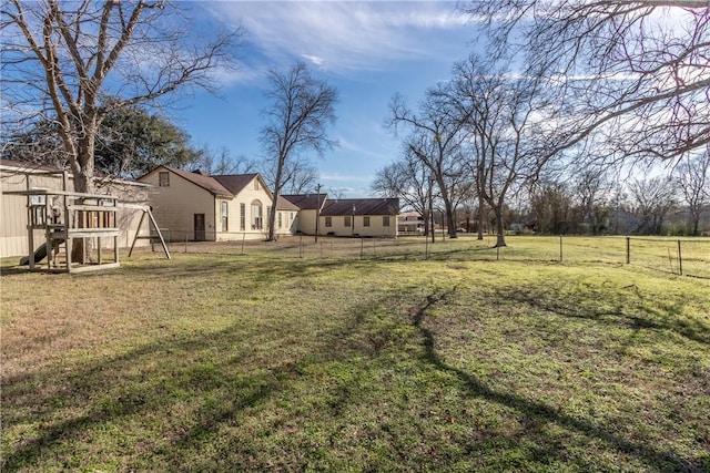 view of yard with a playground and a fenced backyard