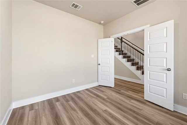 empty room featuring wood-type flooring