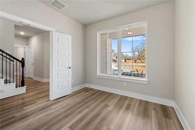 spare room with hardwood / wood-style flooring