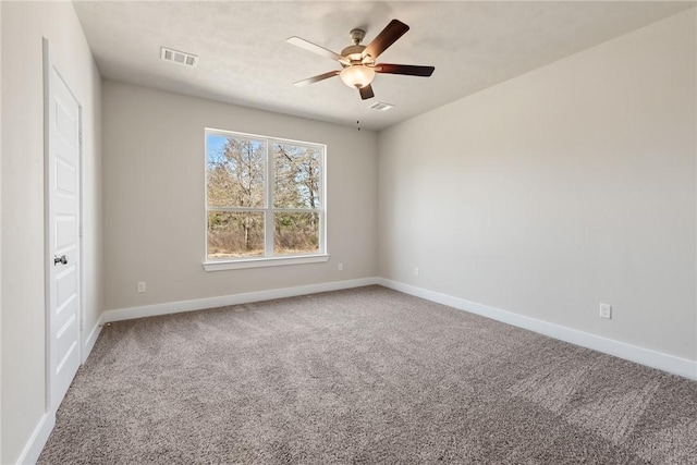 spare room with ceiling fan and carpet