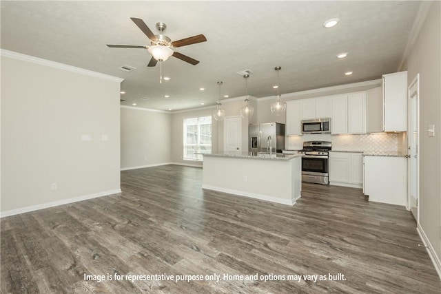 kitchen featuring white cabinets, appliances with stainless steel finishes, a center island with sink, and dark hardwood / wood-style floors