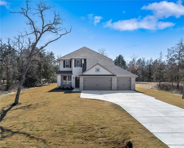 view of front facade with a garage and a front lawn