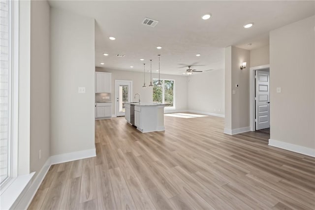 interior space featuring ceiling fan, sink, and light hardwood / wood-style flooring